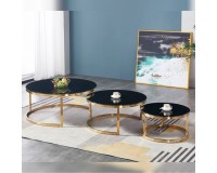A trio of tables for a living room glass with a titanium gold plating.